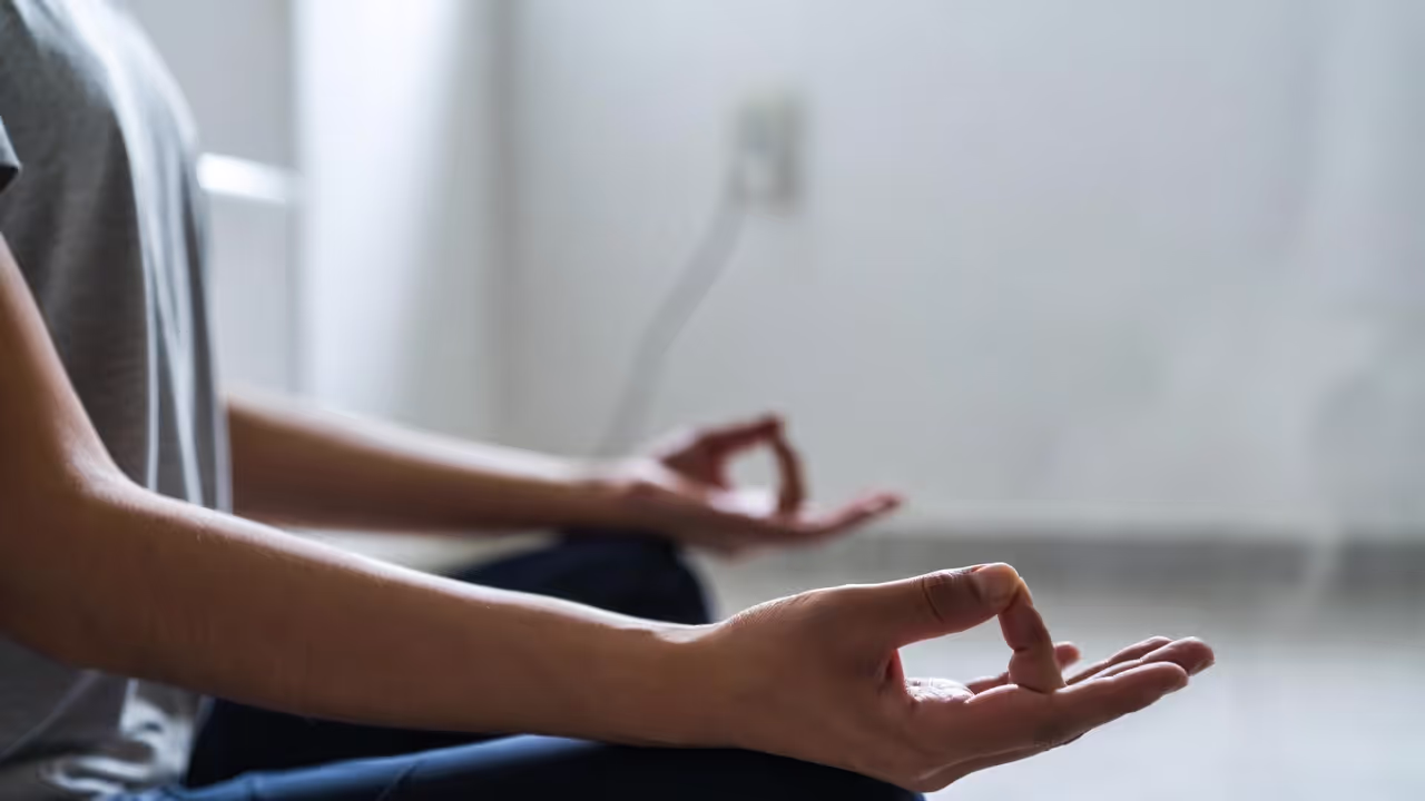 Person practicing deep breathing to reduce anxiety