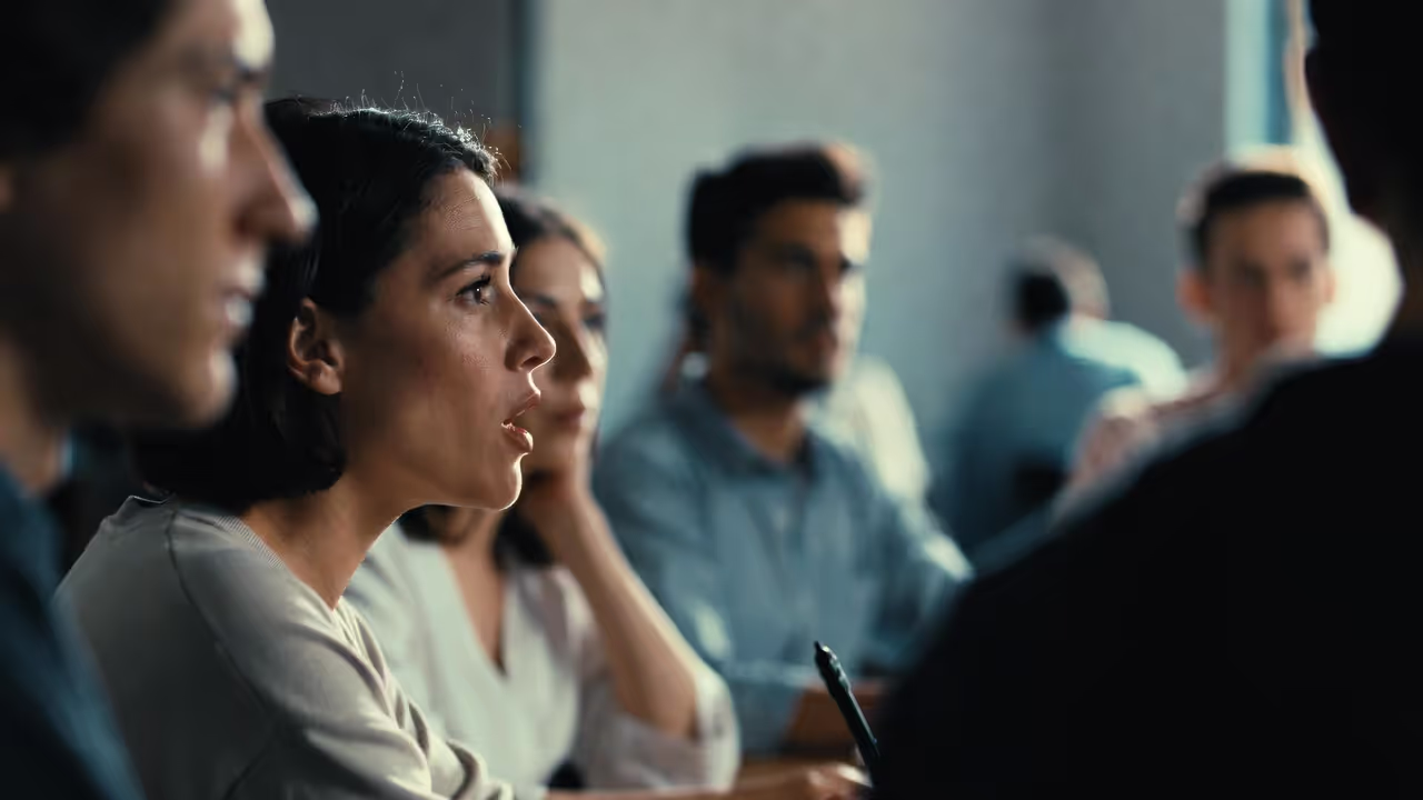 Person speaking confidently in a small group setting